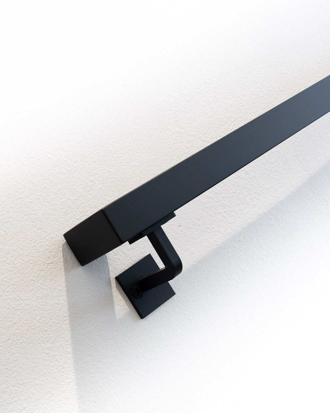 close of view of the 1.5"x1.5" Metal Handrail's bottom bracket and wall return