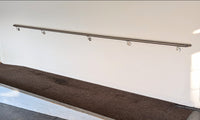 Stainless steel handrail on wall