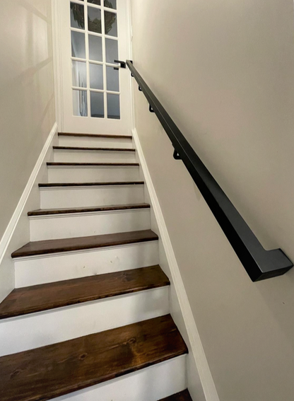 1.5"x1.5" Metal Handrail ascending 9 stairs with walls on each side to a door with glass panes